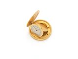 gold plated pocket watch on a white surface with a white background