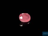 a pink diamond on a black background