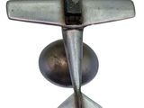 a metal object that looks like an airplane on a white background