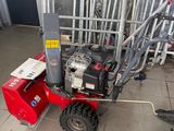 a small red machine that is sitting on the ground