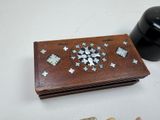 a small wooden box with a mosaic design on it