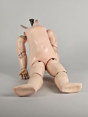 a wooden doll with a knife stuck in it ' s head