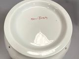 two plates and a bowl sitting on a table