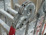 a close up of a metal gate with a red handle