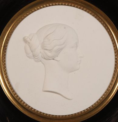 un gros plan sur la photo de la tête d'une femme dans un cadre doré