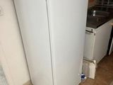 a white refrigerator sitting in a kitchen next to a sink