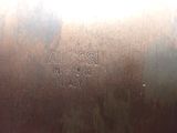 a close up of a metal plate with a name on it