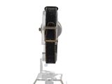 a watch that is sitting on a stand on a white surface