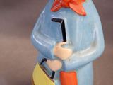 a figurine of a man with a hat and a suitcase