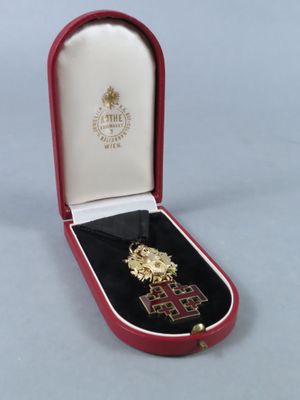 an image of a red case with a gold cross in it