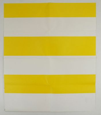 yellow and white striped wall hanging on a white wall