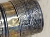 a close up of a silver ring on a wooden surface