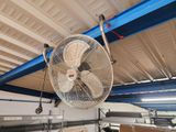 a fan that is hanging from the ceiling in a room
