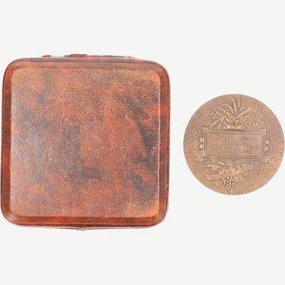 a small metal box with a coin next to it