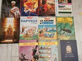 a lot of books that are sitting on the floor