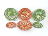 many plates and bowls that are sitting on a table
