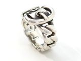silver ring with a black stone in the middle of it on a white surface