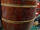 a large wooden bucket sitting on top of a green table