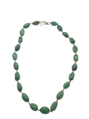 a close up of a necklace with green beads on a white background