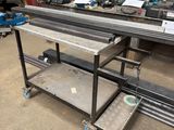 a metal table with a metal tray on it in a warehouse