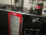 a small refrigerator and a mini fridge in the corner of a room