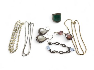 several different types of jewelry are arranged on a white surface