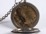 a close up of a pocket watch with a chain