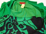 a green shirt with black and green designs on it