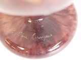 a close up of a glass vase with a writing on it