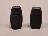 two salt and pepper shakers sitting on a table
