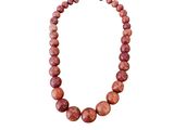 a close up of a necklace on a white background