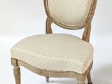 an image of a white chair with a beige upholstered seat