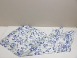 a blue and white floral dress on a white table