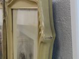 a picture of a dog in a picture frame hanging on a wall