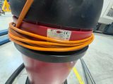 a red and black fire hydrant with a yellow hose