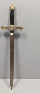 a close up of a knife with a gold handle on a white surface