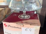 a cake stand with a glass dome on top of it