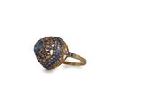 a close up of a gold ring with blue and white diamonds