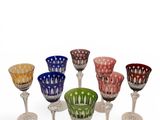 several different colored wine glasses sitting on top of each other