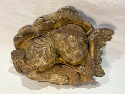 a gold statue of a woman with a flower in her hair