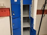 two blue lockers in the corner of a room