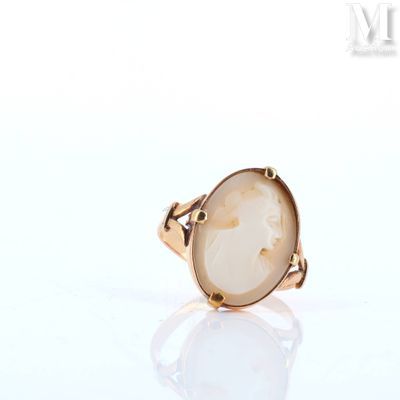 a close up of a ring with a white stone in it