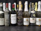 many bottles of wine lined up on a table