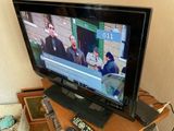 a flat screen tv sitting on top of a wooden table