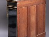 an old wooden cabinet with a marble top and black doors