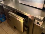 a large stainless steel counter with a microwave in it