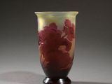 vase with red flowers on a black base on a gray background