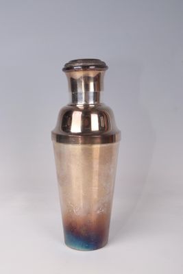 a silver and blue vase sitting on a white surface