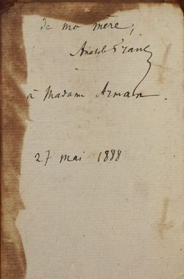an old book with writing on it sitting on top of a table
