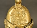 gold helmet on a stand with a black background